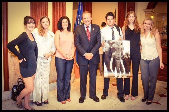 Senator Raymond J. Lesniak stands with advocates from Elephants DC and the Humane Society after the historic passage of New Jersey's ivory and rhino horn sales ban. The elephant pictured is Satao, the largest tusker in Kenya recently slaughtered by poachers. © Rebecca Nowalski.