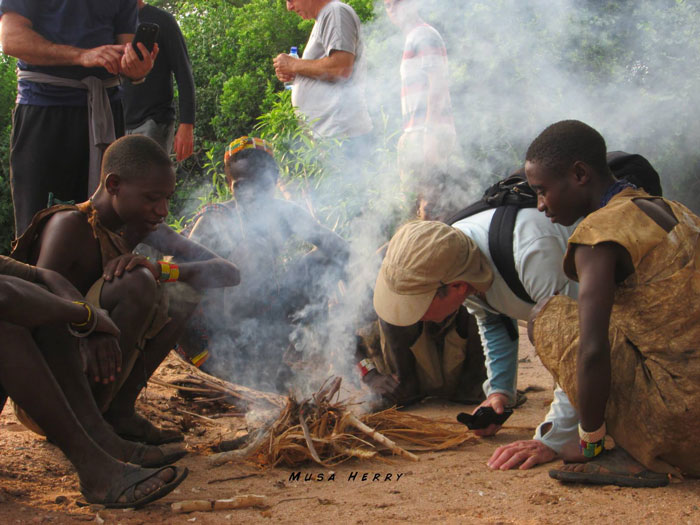 Hadzabe-try-getting-fire-going-with-tourists-