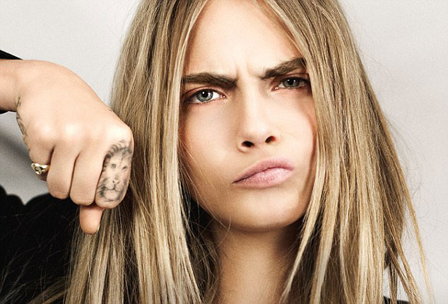 Cara Delevingne poses with a lion cub for TAG Heuer - Africa Geographic