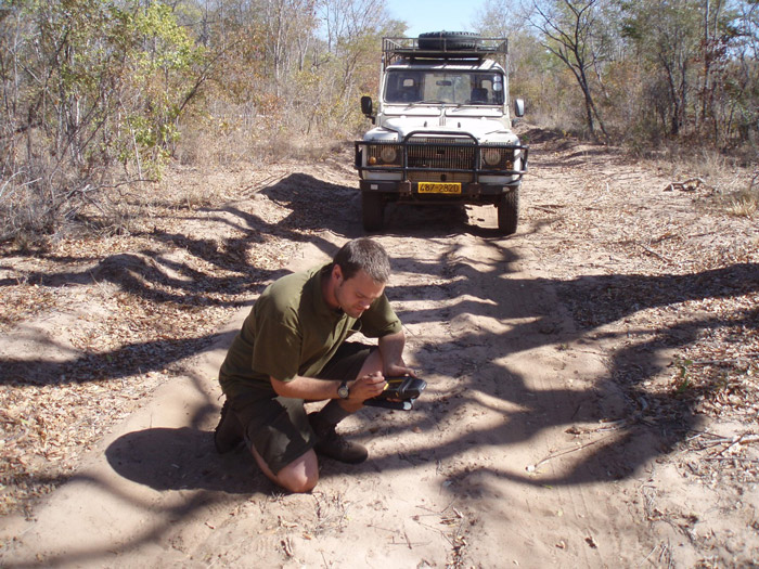 The author recording carnivore spoor in Zimbabwe. ©Sam Williams