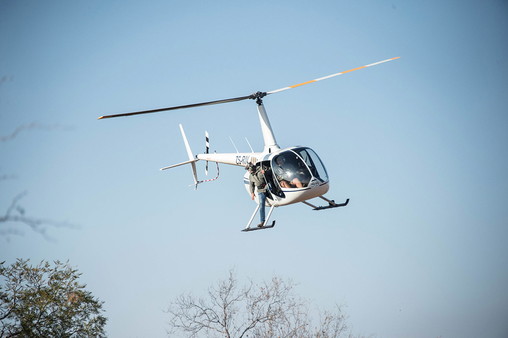 Professional pilot flying a helicopter in the bush