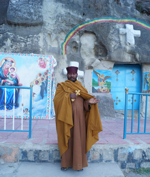 Ethiopian priest standing outside his church