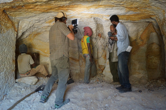 Workmen chiselling out the church from rock