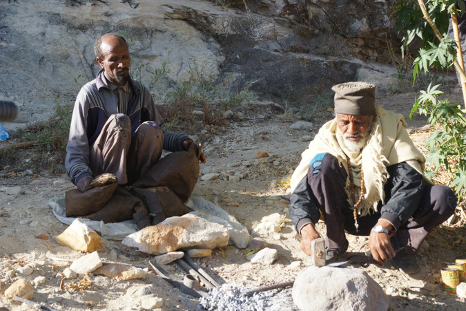 Two men preparing for rock chiselling