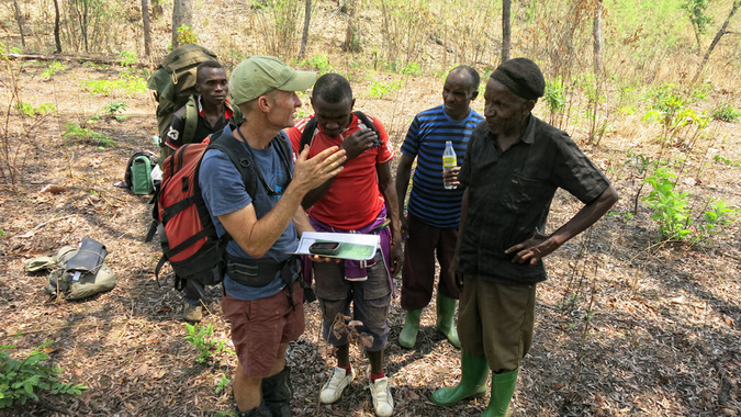 Researcher and guides making plans