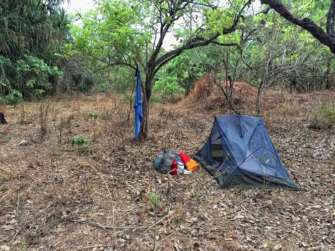 A tent and supplies in the bush