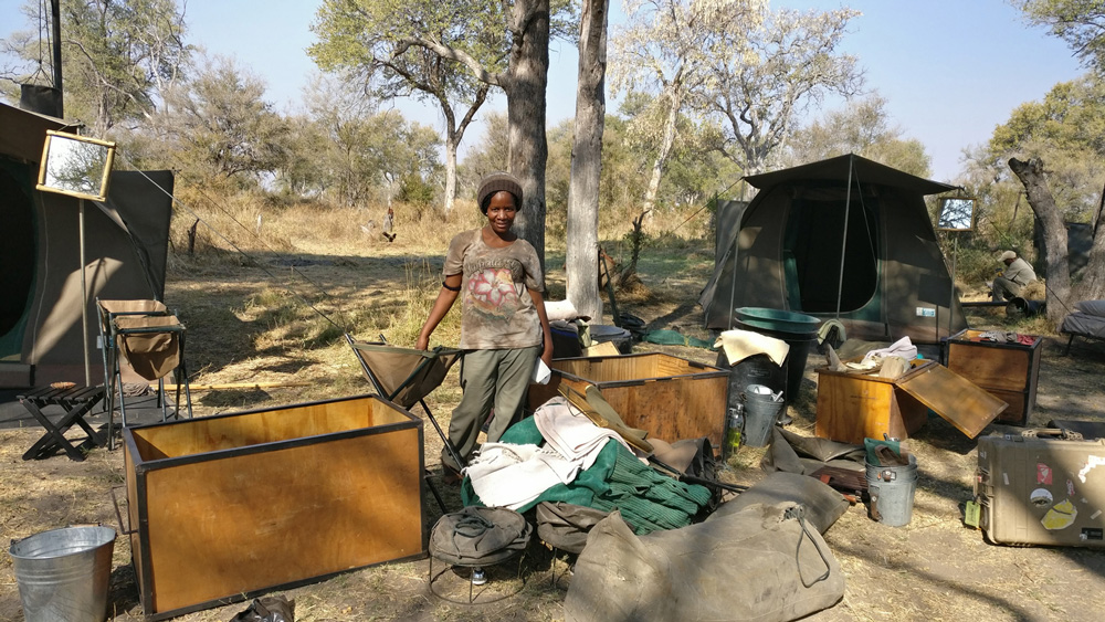 Staff member setting up camping equipment