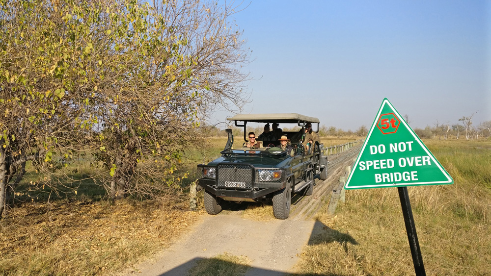 Safari vehicle driving over a bridge