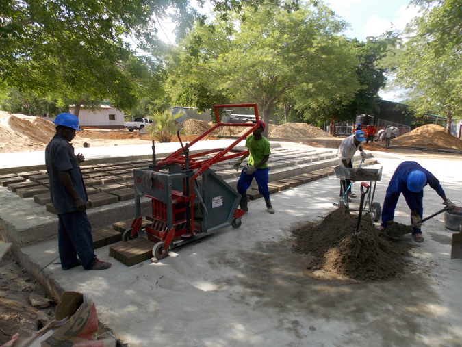 Construction workers making bricks