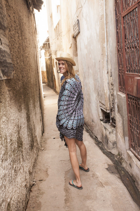 Tourist down a side street in Lamu Town, Kenya