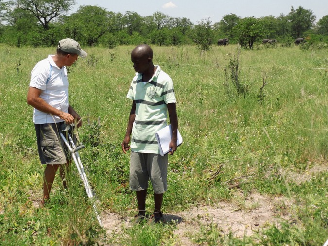 Researches in the field in Botswana with elephant in background