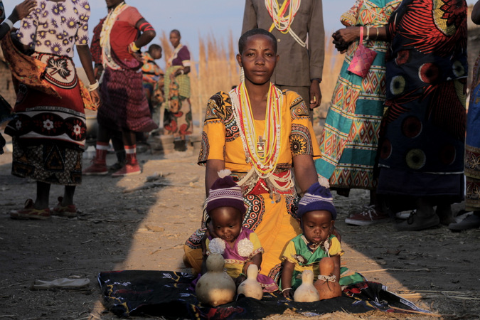 Sukuma woman with two children in her village in Tanzania