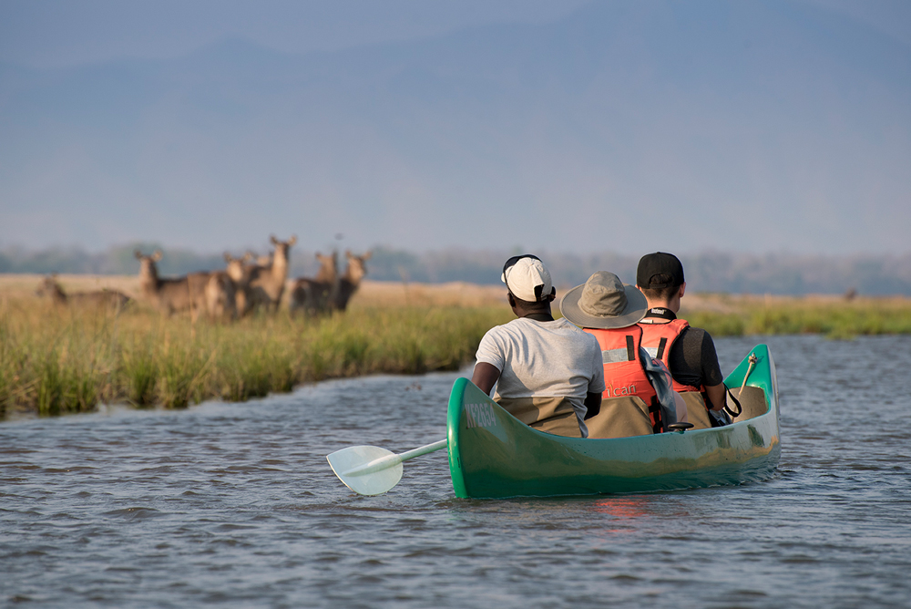 Group of people gliding down the Zambezi River