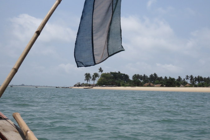 Flag, village and huts on Bumpetuk, Turtle Islands, Sierra Leone