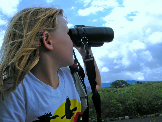 Kid with binoculars while on safari