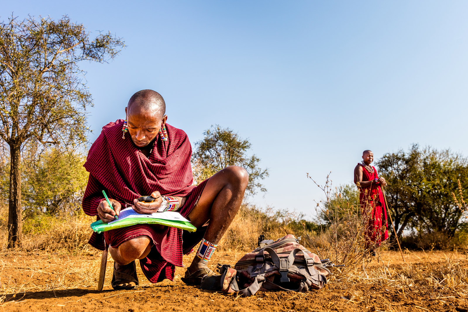 Maasai Kamunu Saitoti takes meticulous notes about his observations while tracking lions in Amboseli