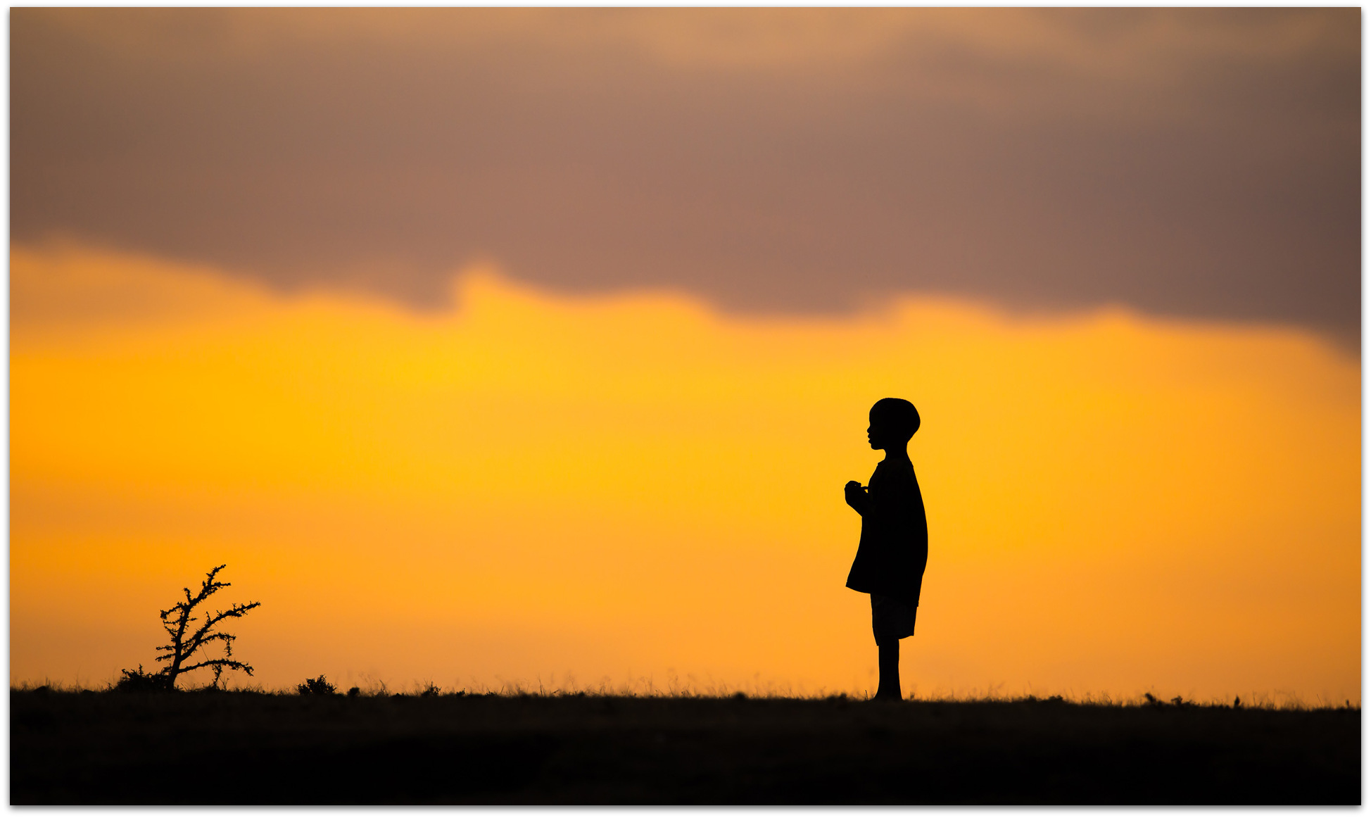 Maasai child against sunset in Maasai Mara