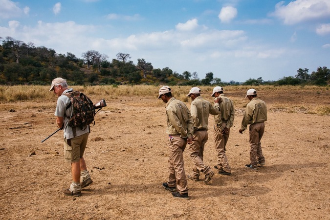 Guide and four trackers searching for tracks in the Makuleke Concession 