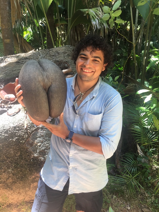 The author holding the nut of a coco de mer
