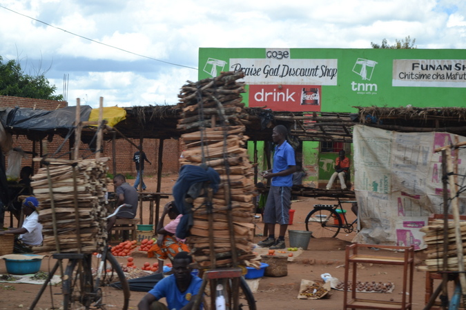 Selling wood at a market in Malawi