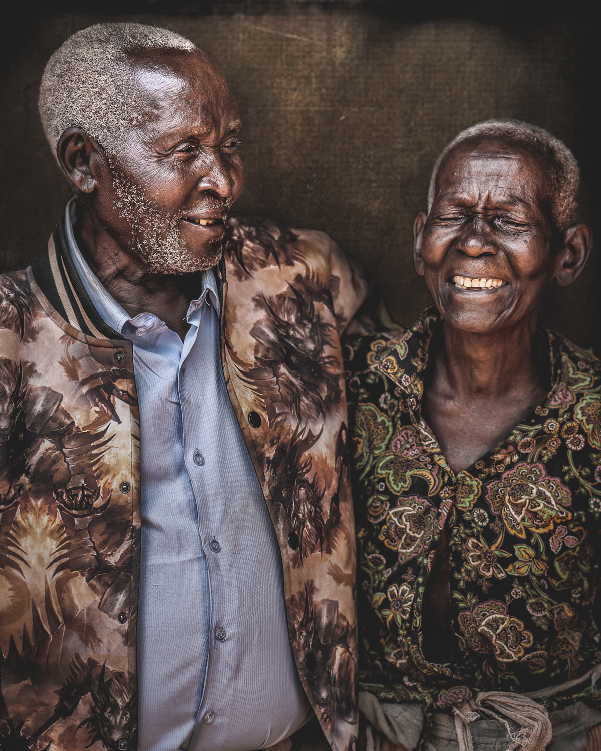 Mzee (100) poses with his wife (90) for a portrait in Jinja, Uganda © Bob Ditty