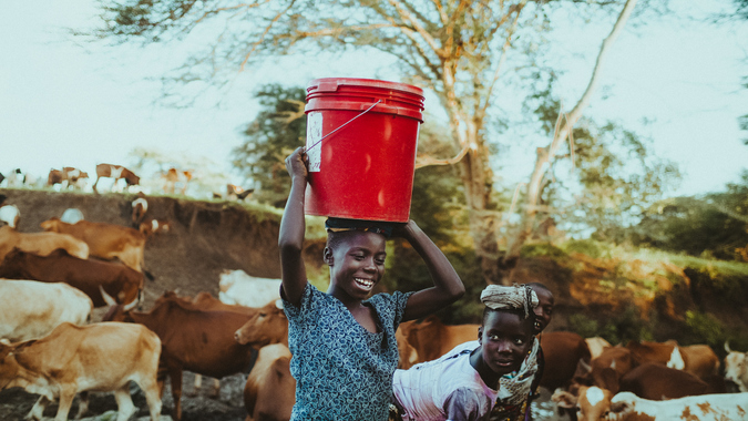 Local woman carrying bucket