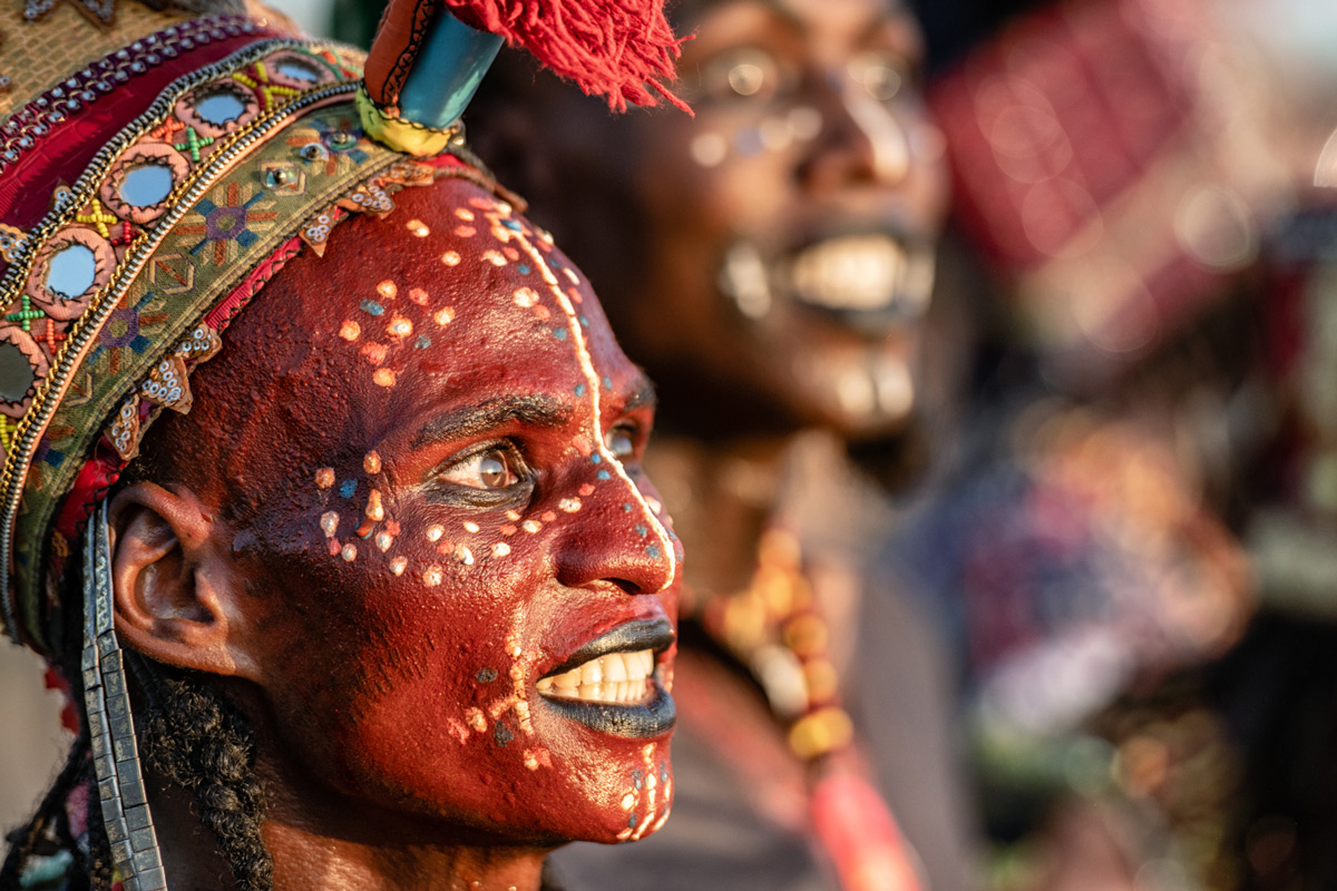 A portrait of a Wodaabe dancer caught by the light of the sun, Chad © Trevor Cole