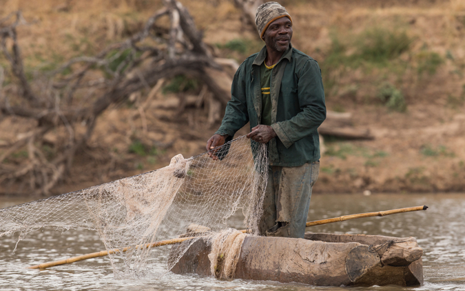 Elias Zimba, a local fisherman laying his nets in the Luangwa River © James Suter / WWF Zambia