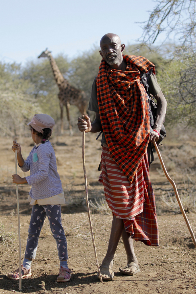 Maasai warrior Leska with the author's daughter and a giraffe 