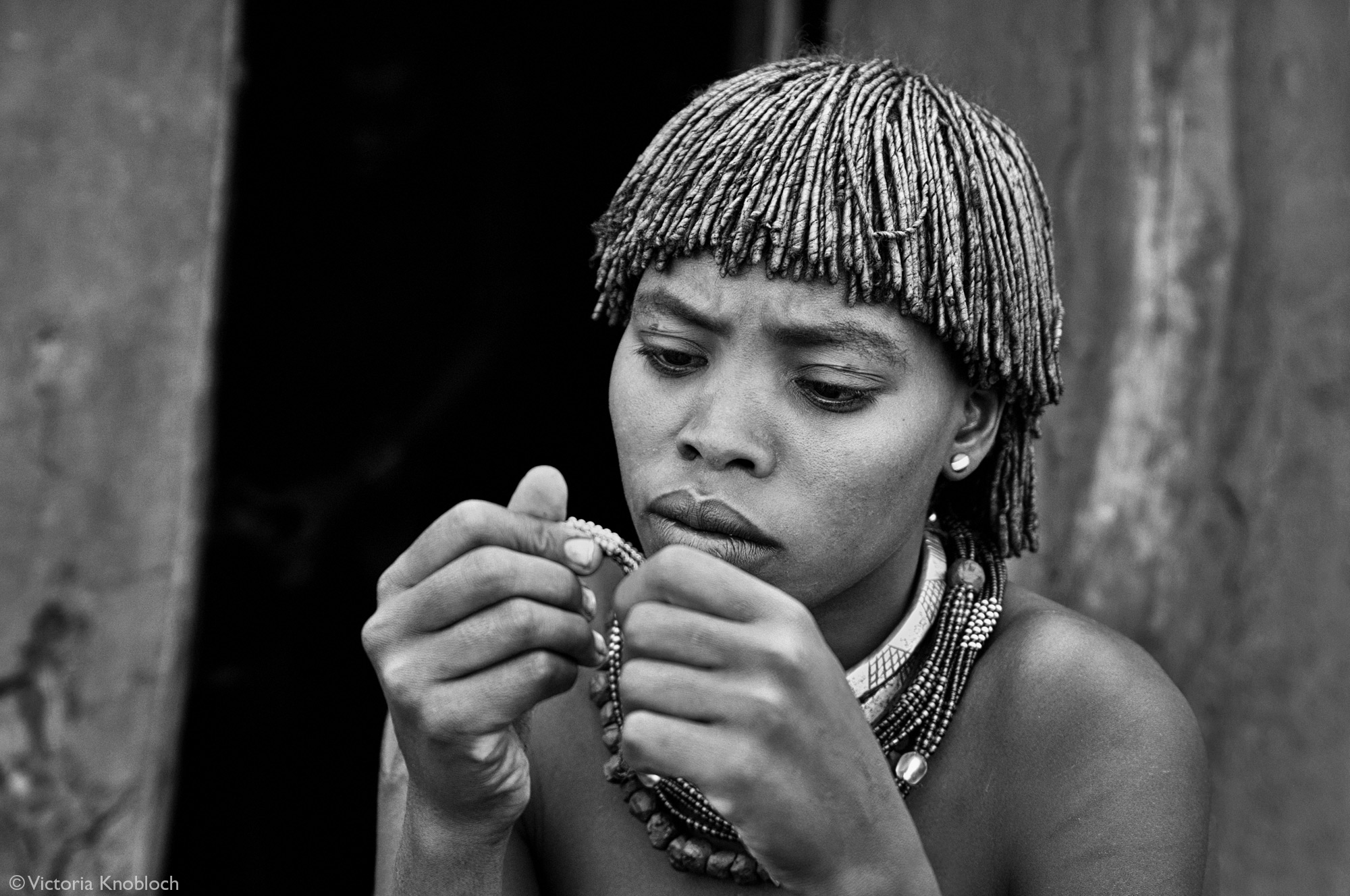 Hamer tribe woman beading, Omo Valley, Ethiopia