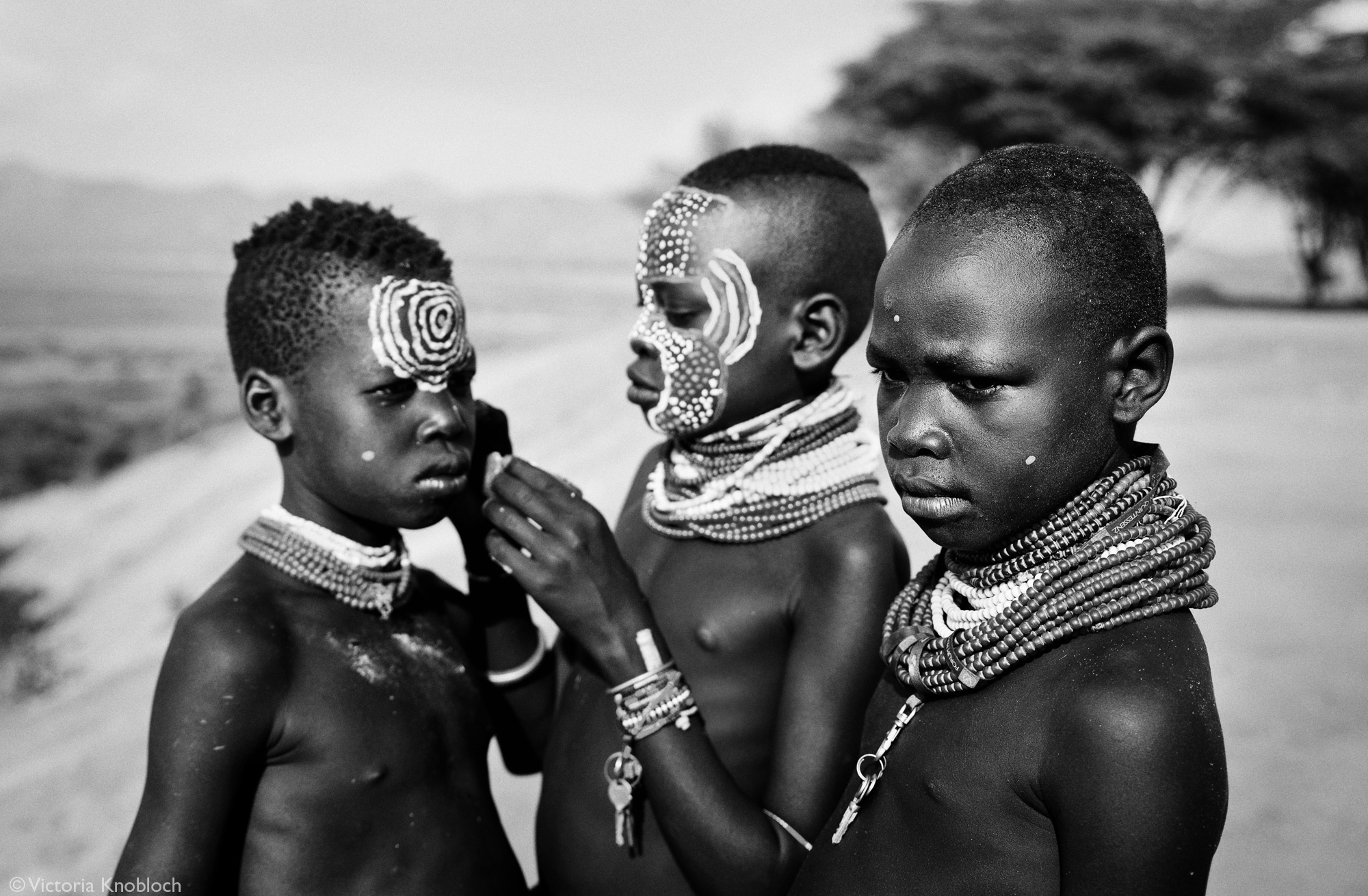 Karo tribe boys applying face paint, Omo Valley, Ethiopia