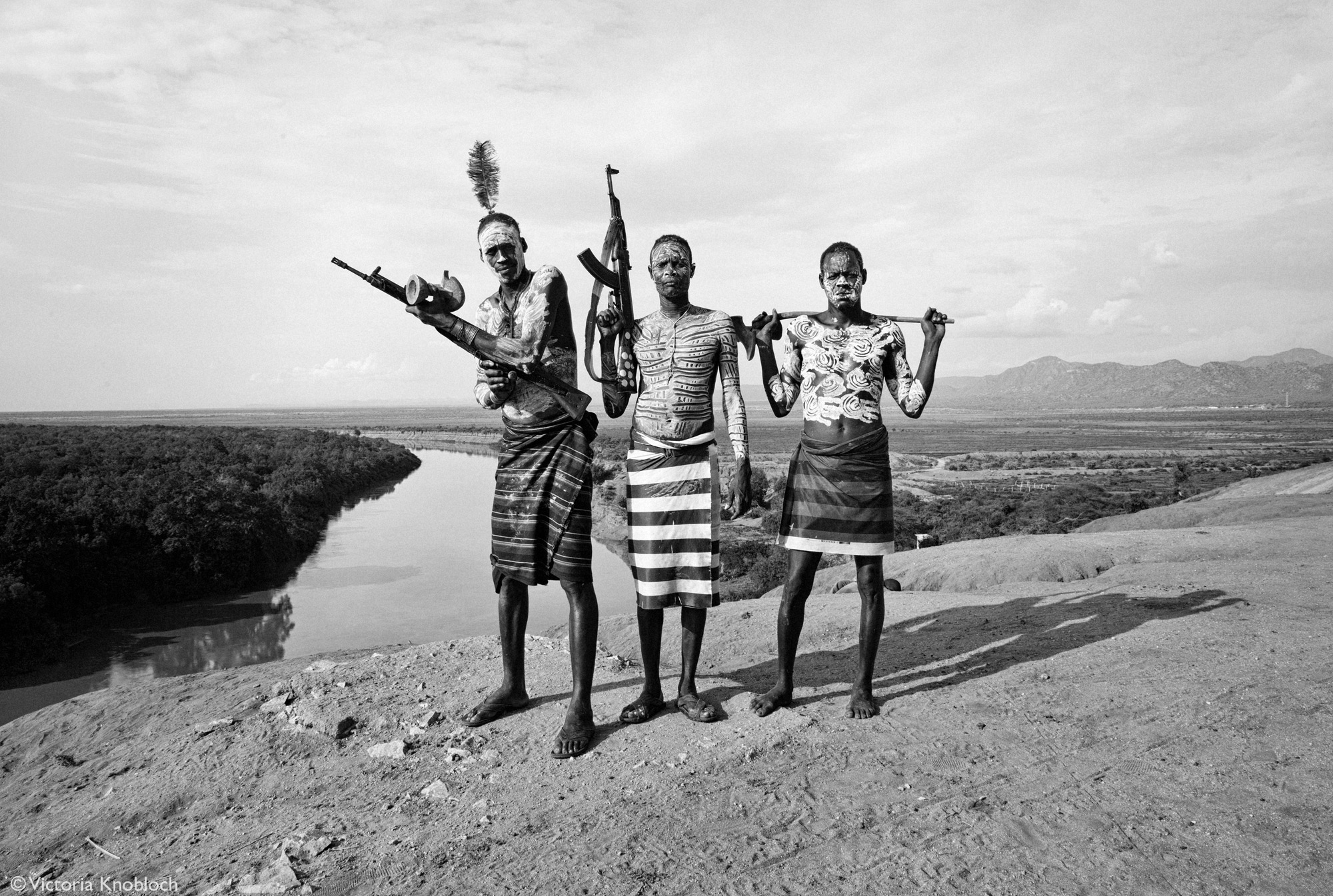 Men from the Karo tribe posing with their AK47s, Omo Valley, Ethiopia