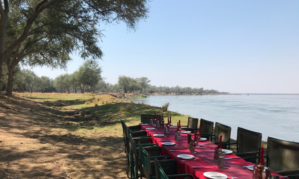 Table and chair for guests along the shore of Zambezi River in Zambia