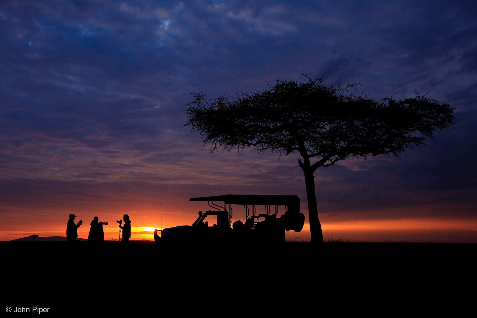 The essence of a safari, set against a magical African sunrise. Mara North Conservancy, Kenya © John Piper